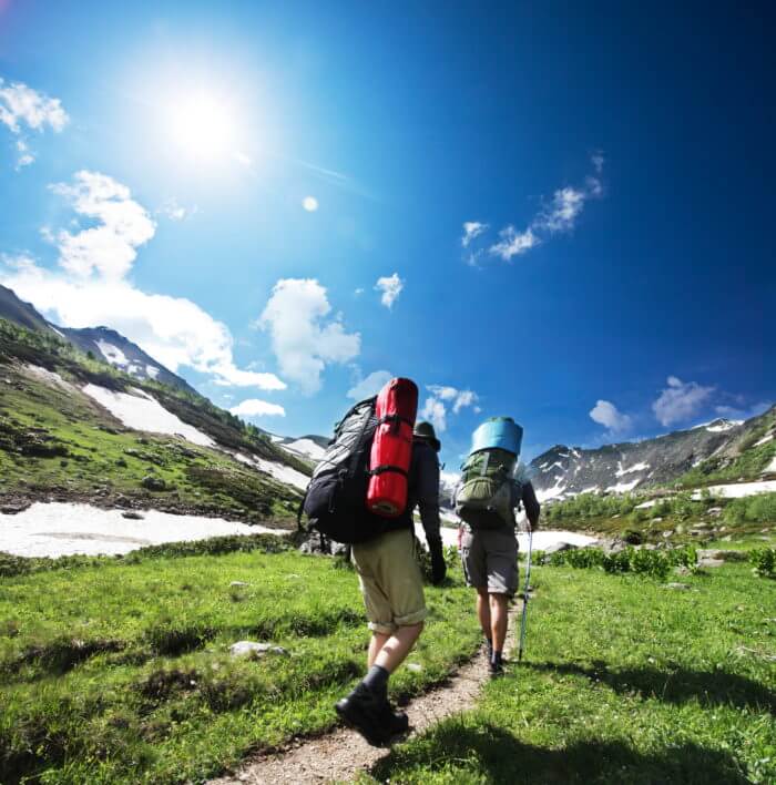 Hikers trekking up a mountain trail with Boulder Salt packets for hydration and electrolyte support during outdoor activities.