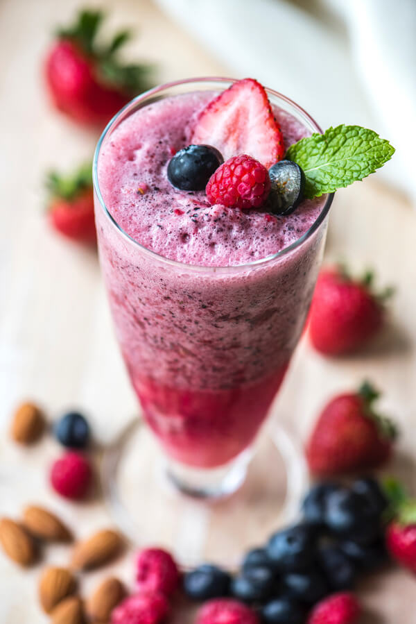 Berry smoothie topped with fresh strawberries and mint, made using Boulder Salt for balanced nutrition and great taste